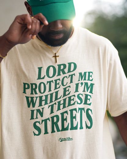 Lord Protect Me While I‚Äö√Ñ√¥m In These Streets Tee in Vintage White