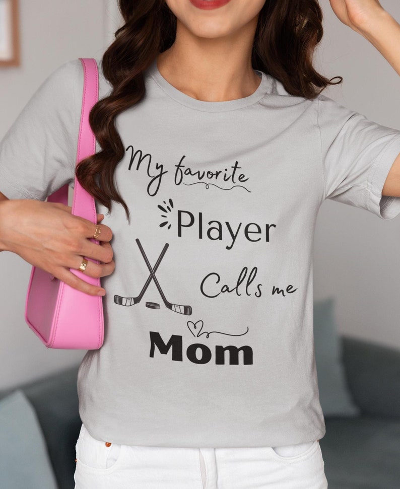 Hockey Mom Tee, My Favorite Player Calls Me Mom T-Shirt, Women's Sports Shirt, Hockey puck Heart Design, Mom Gift Shirt, Cute Mom TeeHockey Mom Tee, My Favorite Player Calls Me Mom T-Shirt, Women's Sports Shirt, Hockey puck Heart Design, Mom Gift Shirt, Cute Mom Tee